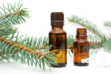 Natural beauty remedy. Small bottle of essential pine oil, pine tree twigs, alternative medicine