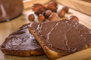 Chocolate cream with nuts at wooden tray.Close up shoot.