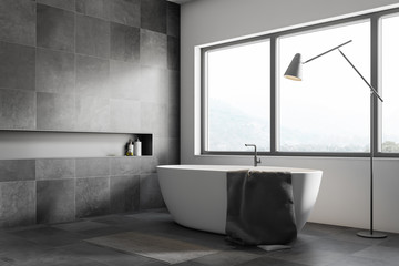 Gray tile bathroom corner with tub