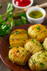 Hasselback potatoes on wooden surface