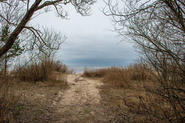 country gravel road with old and broken asphalt