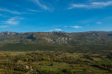 Obraz premium Mountain valley. Autumn morning in the mountains under the blue sky with clouds. Blurred background and soft focus.