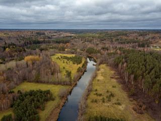 drone image. aerial view of rural area with snake river in forest