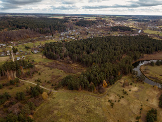 Obraz premium drone image. aerial view of rural area with snake river in forest