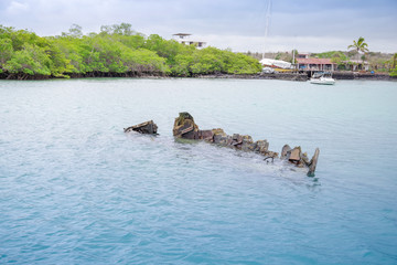 Sunken sailboat in Galapagos in a beautiful blue water