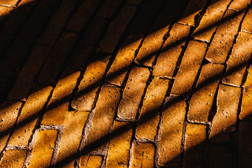 Sun rays and shadows in the brick road