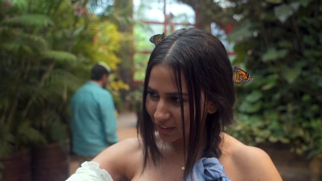 Slow Motion: Close-up of Pretty Young Woman with Butterflies in Her Hair