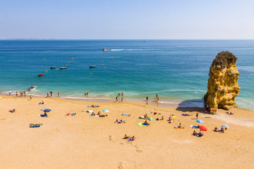 Fototapeta premium Praia da Dona Ana beach, Lagos, Algarve region, Portugal. Praia Dona Ana surrounded by steep colourful strata cliffs. One of the most picturesque beaches in Algarve. One of the best beach of Portugal