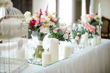 wedding mirror table with flowers and candles close to