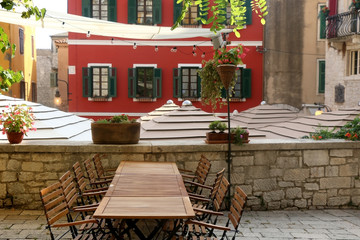 Charming cafe in a colorful narrow street in Sibenik, Croatia. Traditional Mediterranean architecture. Selective focus.