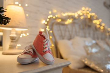 pink newborn boots on a christmas background