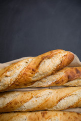 Close-Up Of Baguettes on cutting board with knife