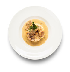 quail in a sauce with a side dish of mashed potatoes on a round white plate