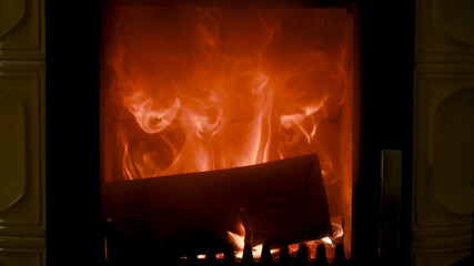 Fire in stove, close up, firewood burning