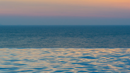 infinity swimming pool with ocean background