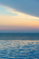 infinity swimming pool with ocean background