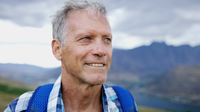 Caucasian senior male hiking using binoculars New Zealand