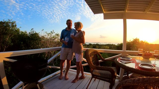 Mature couple on home decking at sunset Bahamas