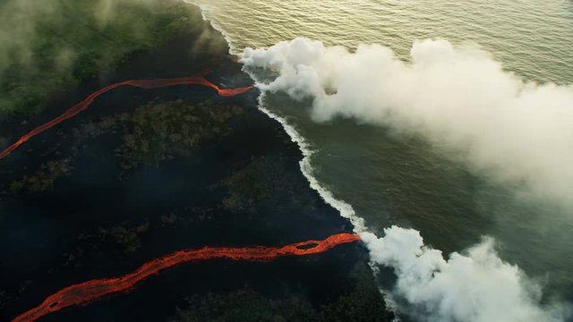 Aerial view red hot lava pouring into Pacific