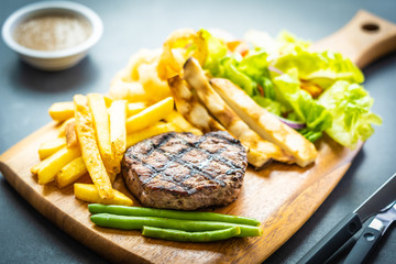 Grilled beef meat steak with french fries sauce and fresh vegetable