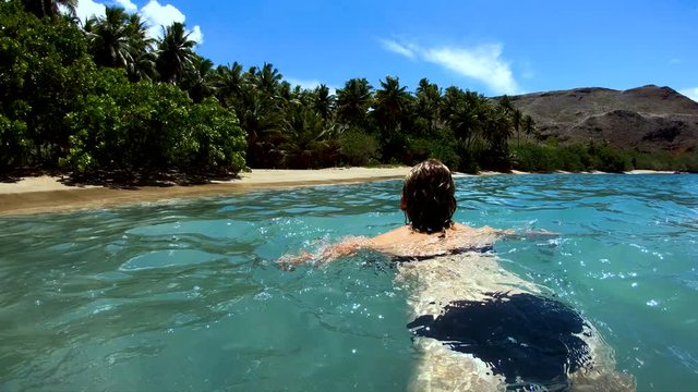 Female on a deserted Island beach Tahuata Marquesas