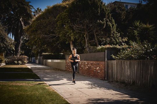 Young man running on footpath