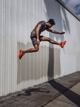 Side view of athlete jumping outdoors