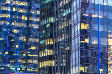 Close up of modern skyscraper illuminated at night.