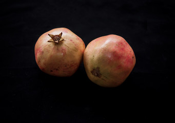 Small ripe fruits of dwarf pomegranate on white background, beautiful fruit harvest from punica granatum var. nana, planted as an ornamental plant in gardens and grown as bonsai tree, vegan concept