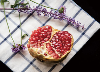 pomegranate seeds over black background