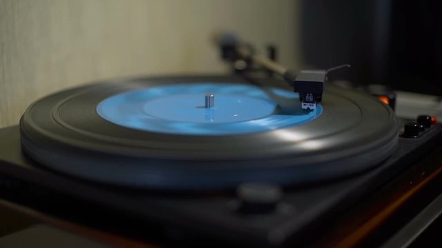 Vintage Turntable Playing Blue Vinyl Record