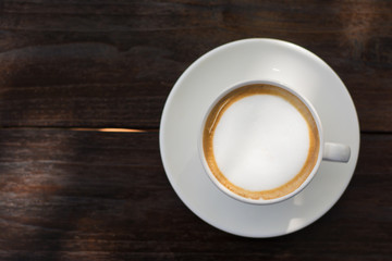 Coffee espresso on wood table nature background in garden,warm tone