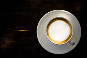 Coffee espresso on wood table nature background in garden,warm tone