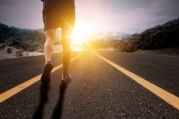 Goal and Strive concept, Runner run on road with sun rising.