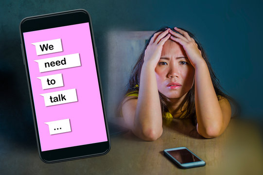 young desperate and sad Asian Korean woman feeling depressed suffering pain and broken heart composite with mobile phone online text in relationship problem and break up