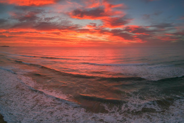 Bright red sunrise over Windang Beach, NSW, Australia