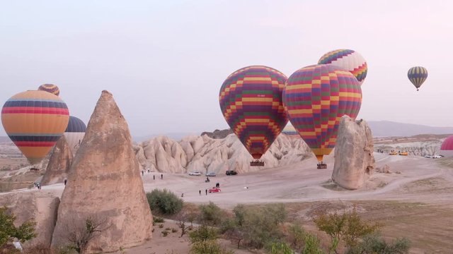 Hot air balloons flying over the rock landscape of Cappadocia, Turkey
