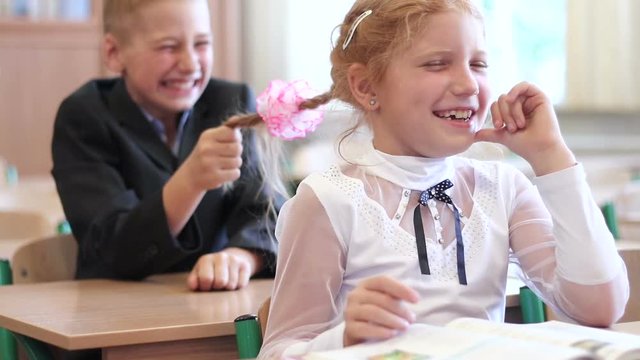 Children at elementary school. School children having a good time, innocent merriment on the lesson.