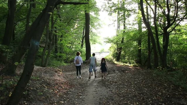 Walking in the forest.  Family's on vacation in the forest is getting to know to the natural world. 