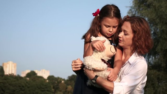 Happy mother and daughter outdoors. Warm family relationships