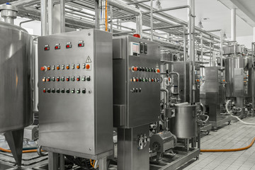 electronic control panel and tank at a milk factory. equipment at the dairy plant
