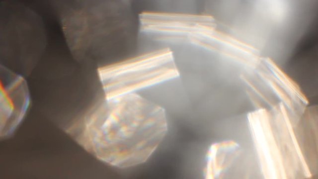 Abstract background - light color flashes and rays on black. Lens flare.  