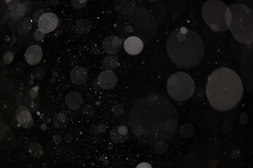 Background of falling snowflakes in the light of a lantern.