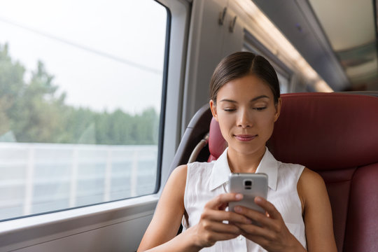 Train commute first class woman using phone texting on mobile phone app work on online wifi device. Asian businesswoman commuter professional. Transport travel lifestyle.
