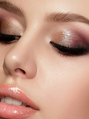 Closeup portrait of young beautiful woman with evening make up. Pink and gold multicolored smokey eyes. Luxury skincare and modern fashion makeup concept. Studio shot. Extreme closeup, partial face - obrazy, fototapety, plakaty