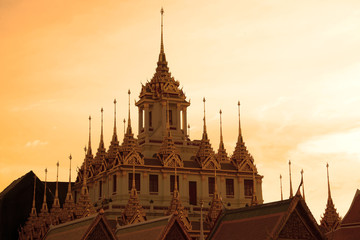 Chedi Loha Prasat of the Buddhist temple Wat Ratchanadda against the background of the sunset sky. Bangkok, Thailand