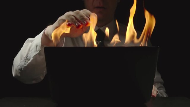 Businessman is shutting burning laptop and grabbing his head - Slow Motion