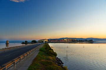 Obraz premium View of Orbetello in lagoon on peninsula Argentario at sunrise. Italy