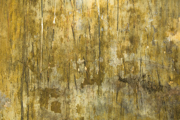Old dirty yellow gray wall with scratches and black spots. Vertical lines. rough surface texture