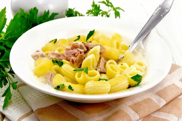 Soup creamy of chicken and pasta in plate on napkin